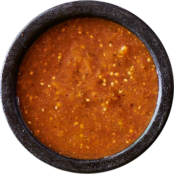 Bowl of red salsa on a white background.